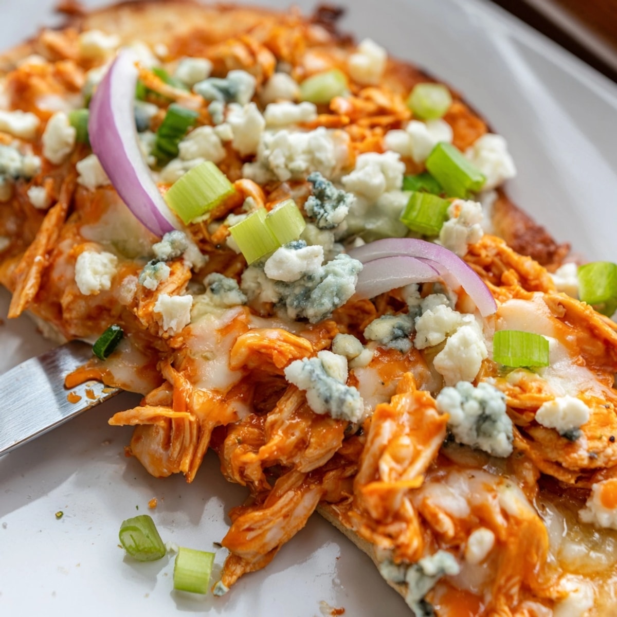 Close-up of a Buffalo Chicken & Blue Cheese Flatbread, bubbly cheese, vibrant toppings.