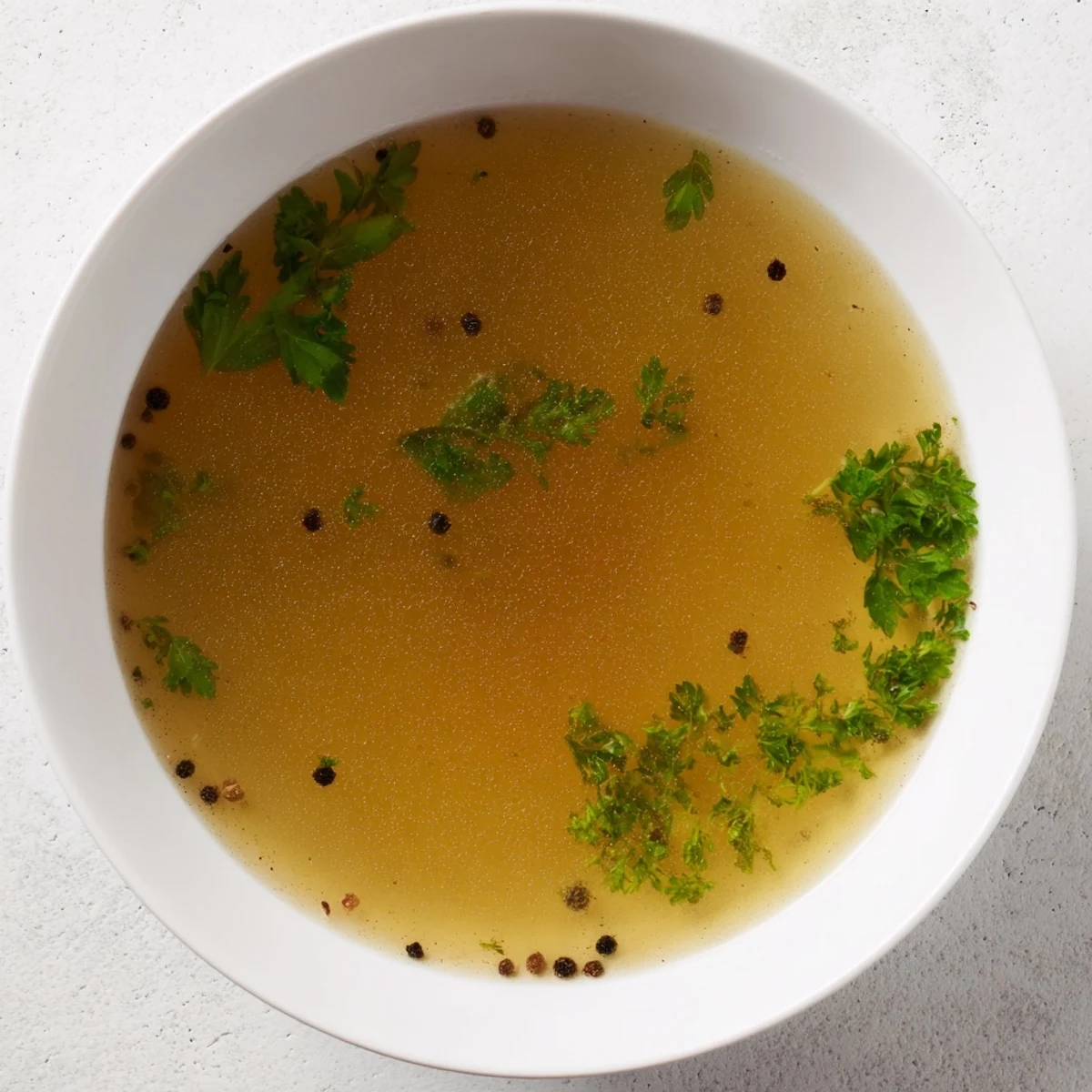 A steaming bowl of homemade beef broth, savory and ready for sipping or cooking.
