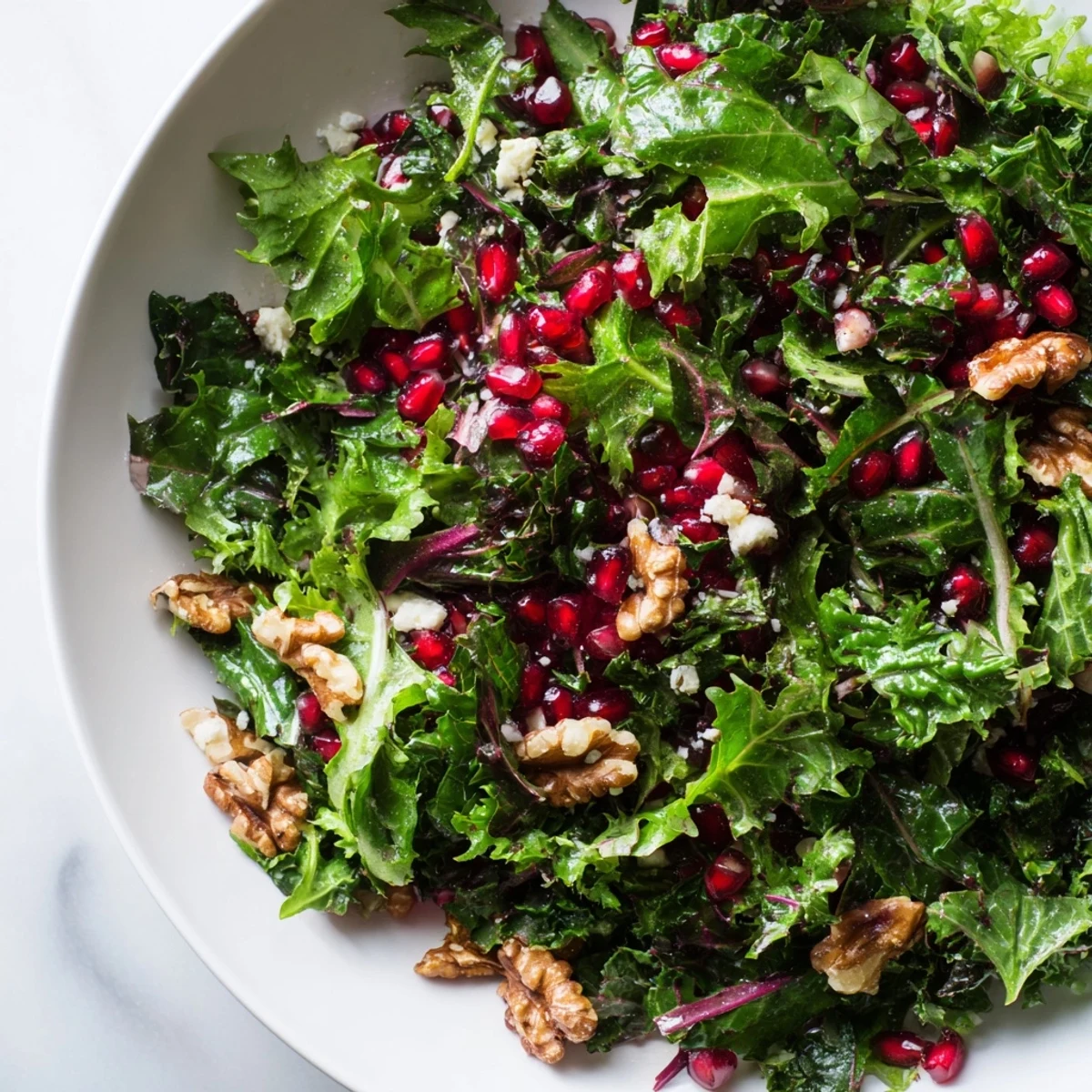 Fresh Winter Greens with Pomegranate Vinaigrette, a light and refreshing salad bursting with flavor, ready to serve.