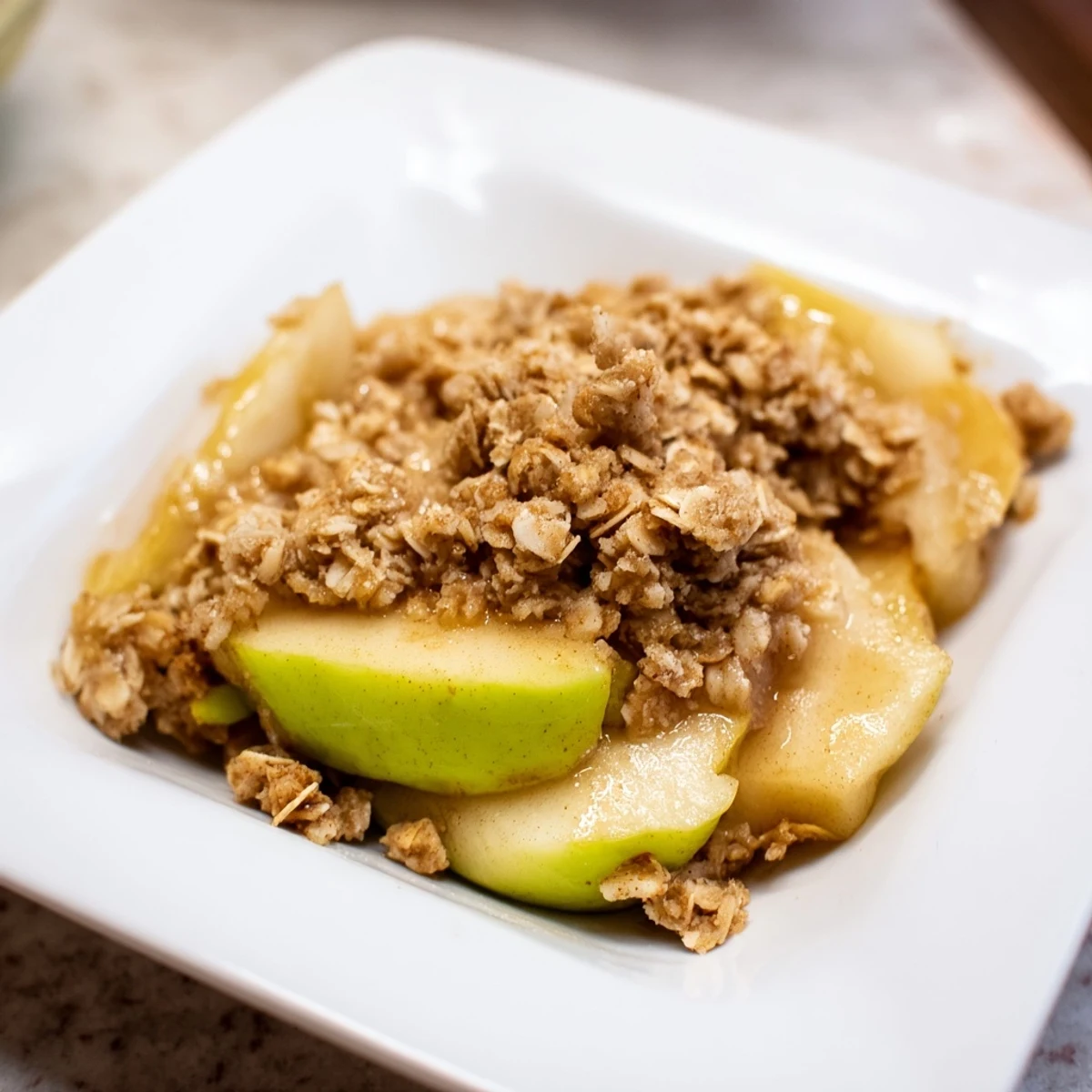 Deliciously rustic Apple Crisp, with a scoop of vanilla ice cream, promising a comforting dessert experience.