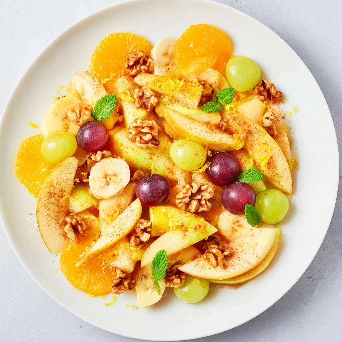 Warm fruit salad glistening with honey, cinnamon, and nutmeg, perfect for a cozy dessert.