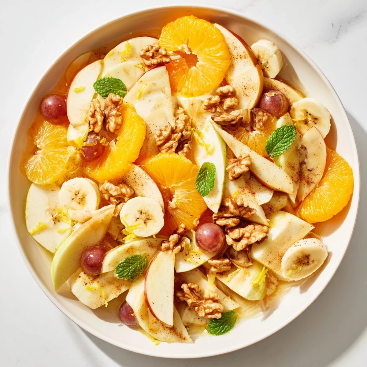 This warm fruit salad shows vibrant, soft fruit pieces ready to be savored warm from the pan.