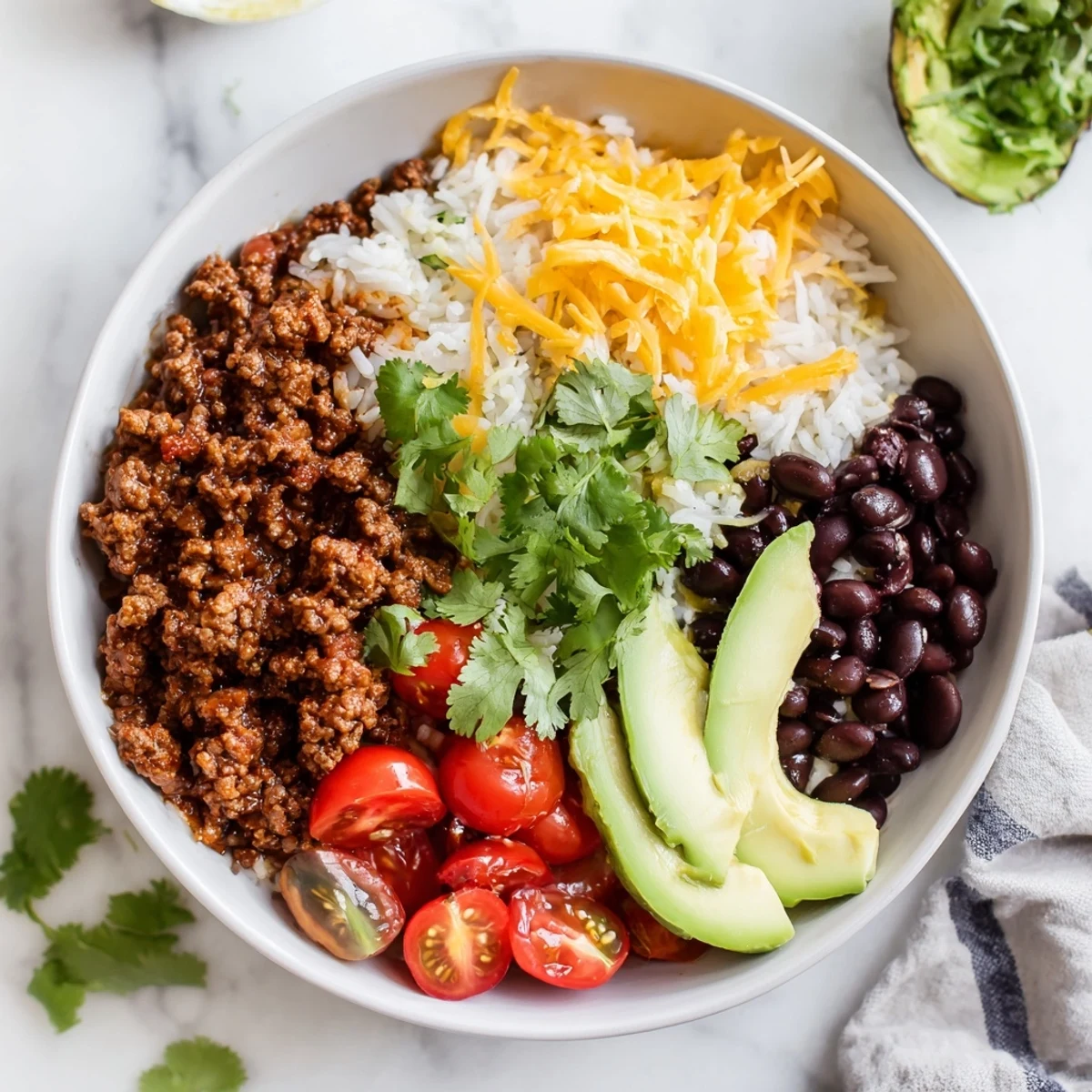 Steaming Beef Burrito Bowls with vibrant toppings, featuring seasoned beef, fluffy rice, and black beans.