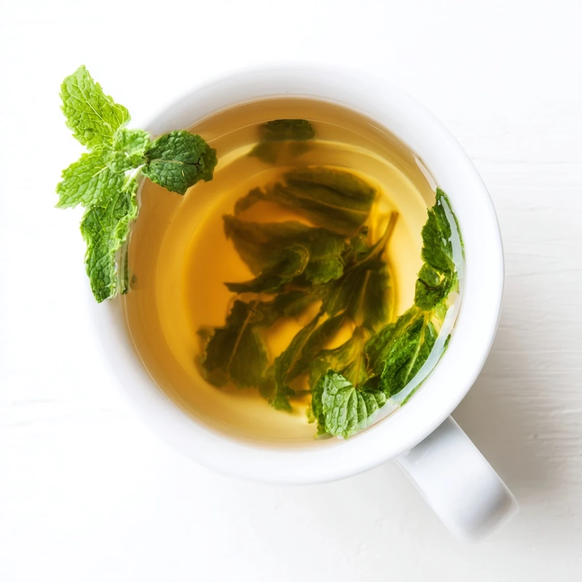 Close-up of Peppermint Tea with Honey showing golden honey swirling into the steaming herbal brew, perfect for relaxation.