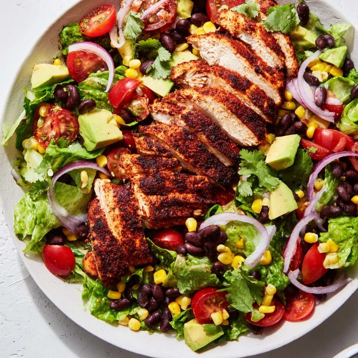 Close-up of Southwest Chicken Salad with Lime Dressing showing juicy chicken, diced bell pepper, corn, and zesty cilantro garnish.
