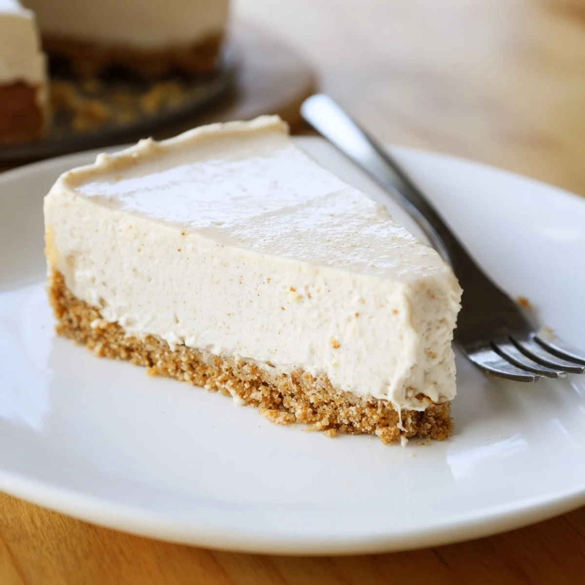 Chilled Irish Cream Cheesecake with a graham cracker crust, drizzled with chocolate and sprinkled with cocoa.