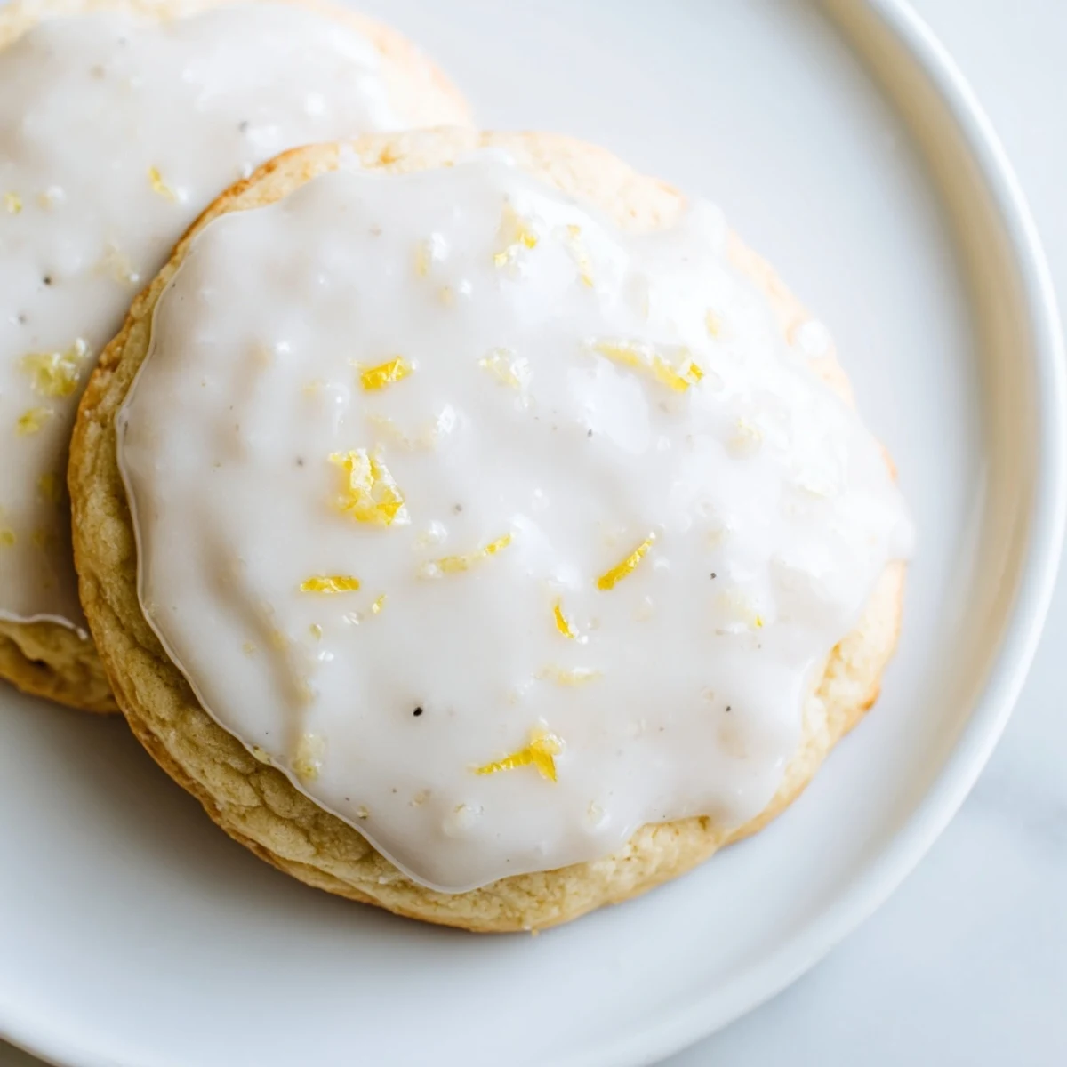A close-up of Lemon Ricotta Cookies with Glaze shows soft texture and sweet drizzle perfect for summer.