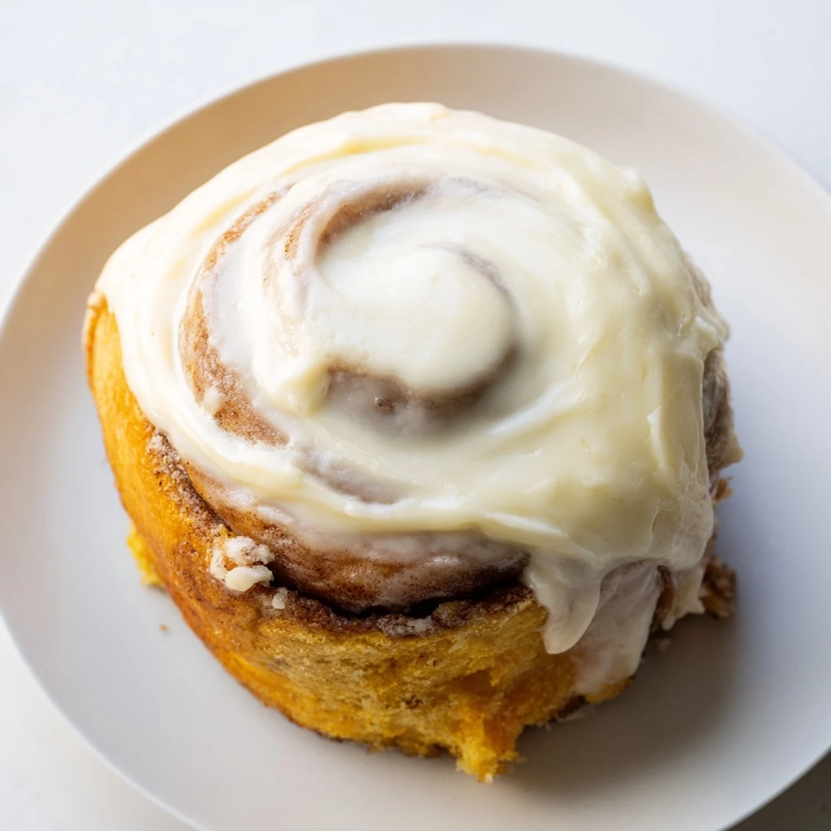 Golden-brown Keto Cinnamon Buns arranged in a round pan, drizzled with sweet icing, perfect for low-carb breakfast.  