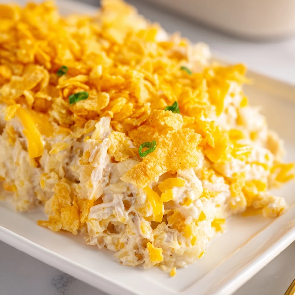 Serving suggestion for Funeral Potatoes with Hashbrowns, perfect alongside a holiday ham or roasted chicken on a festive table.