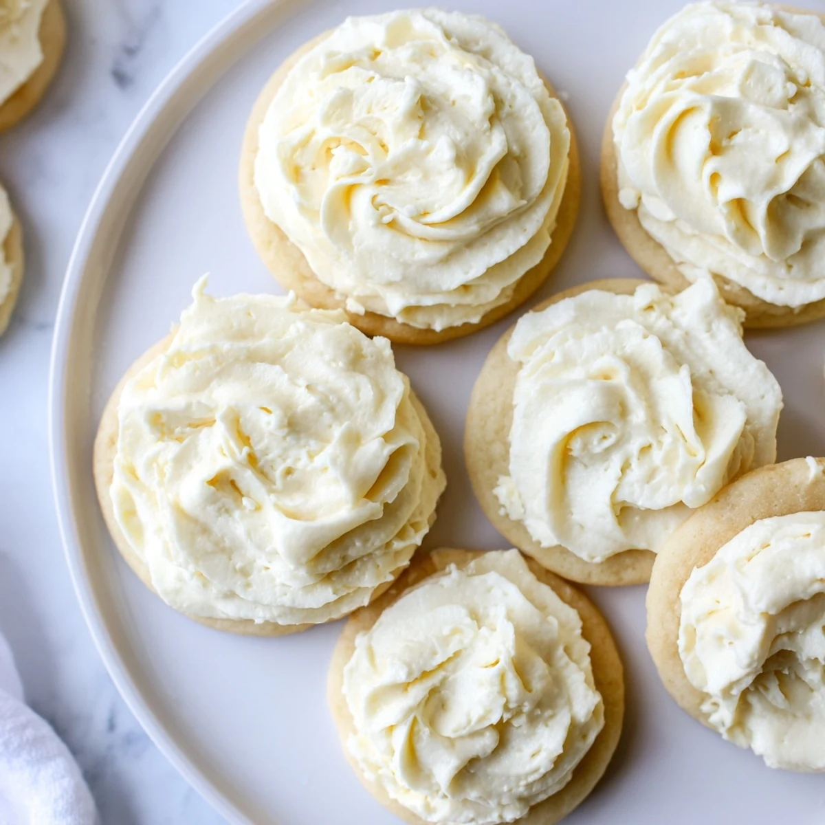 Easy Sugar Cookie Frosting swirled in a mixing bowl, a sweet vanilla buttercream with a slight crust forming.