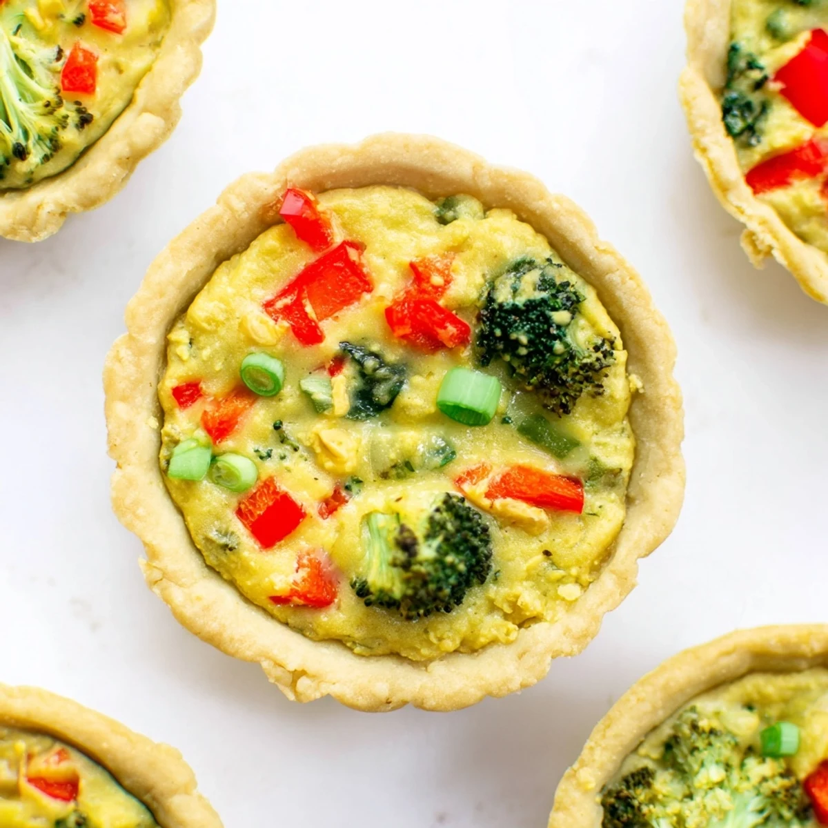 Warm, savory vegan mini quiches served on a platter, ready for a healthy brunch or appetizer party spread.