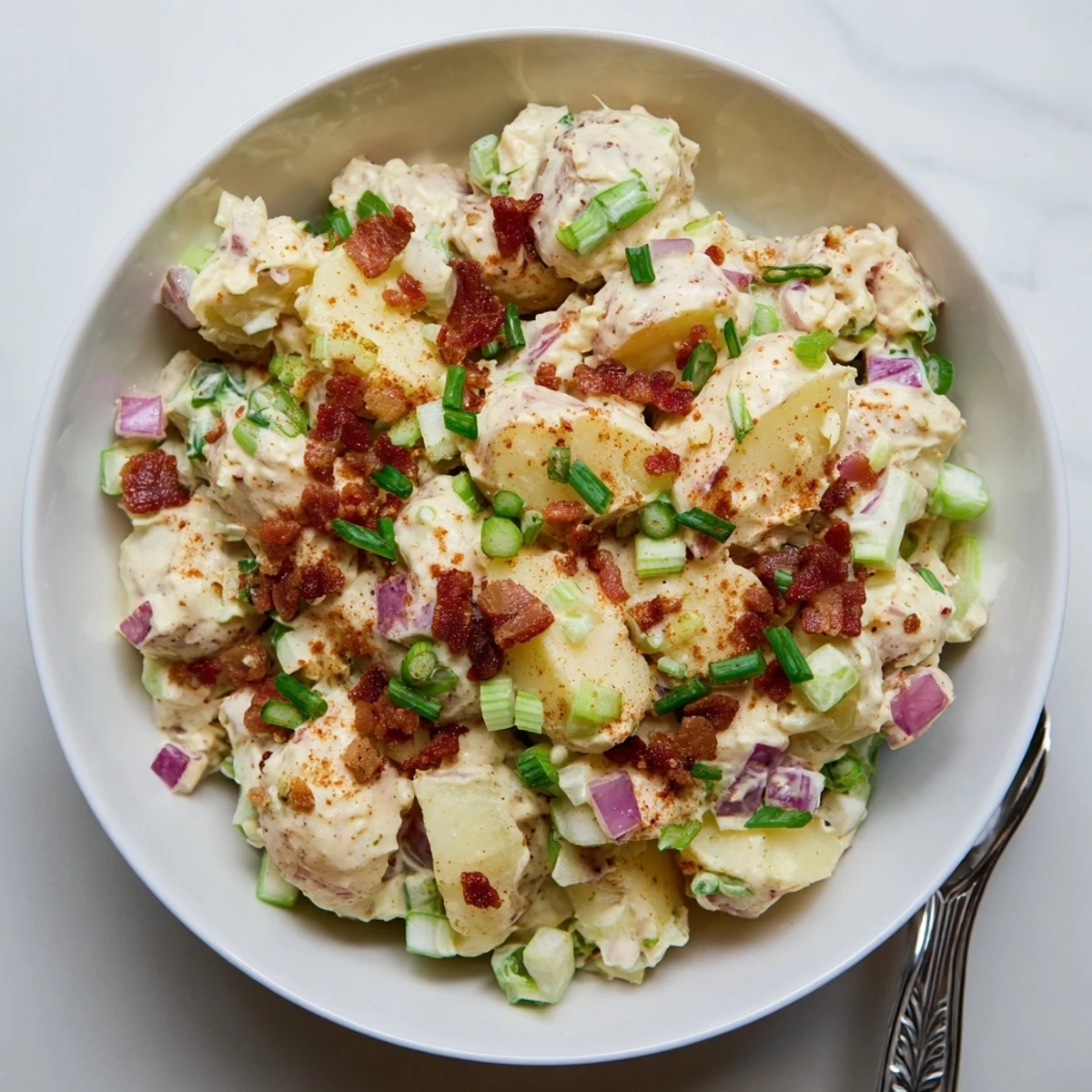 Tender Yukon Gold potatoes tossed in a creamy tangy dressing with crumbled bacon and fresh chives in this Steakhouse Potato Salad.