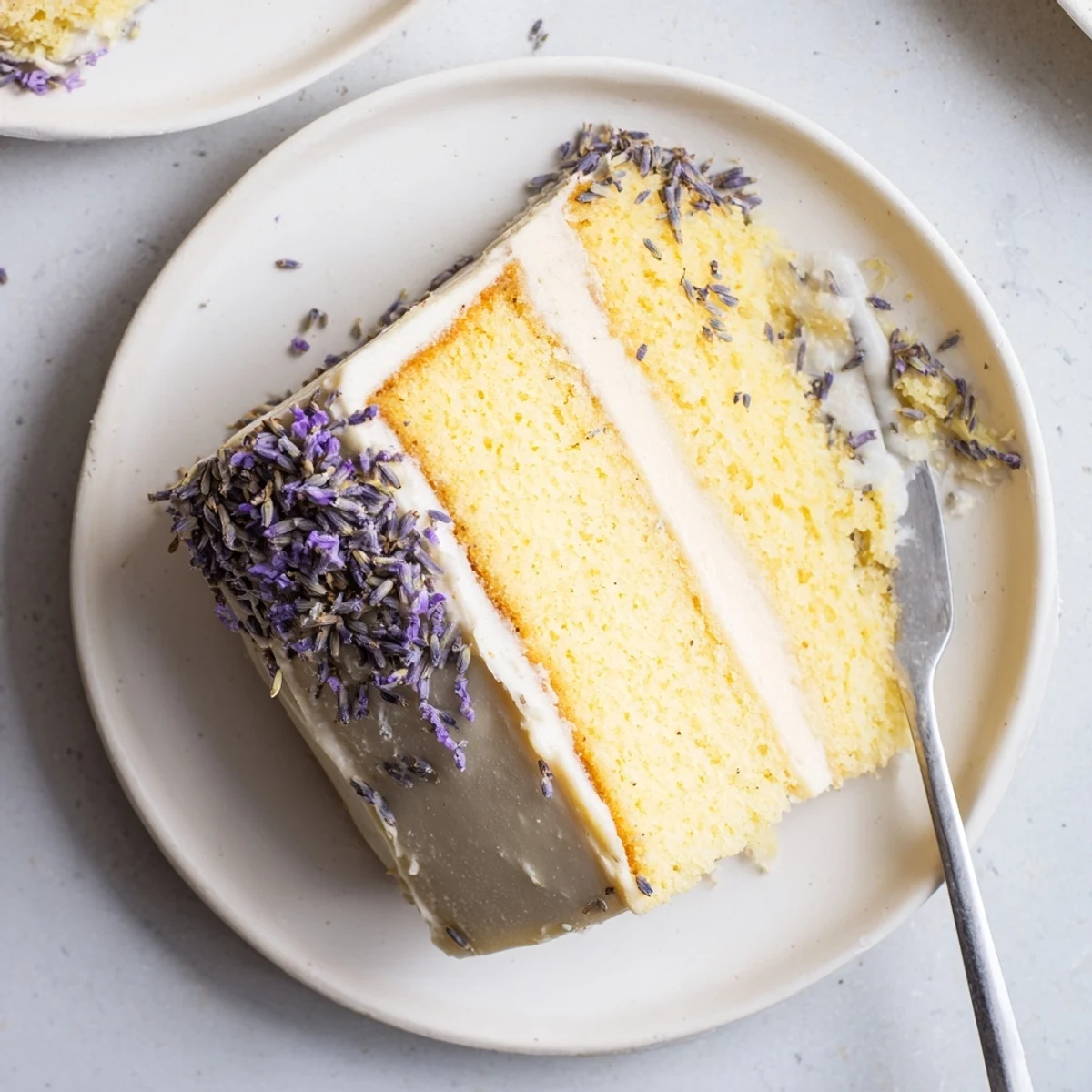 Two-layer London Fog cake with Earl Grey and lavender, frosted with vanilla buttercream and garnished with dried buds.  