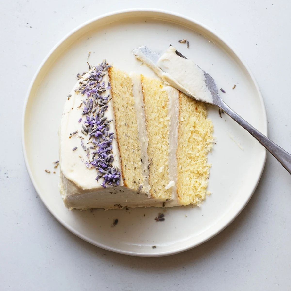 Freshly frosted London Fog cake featuring Earl Grey and lavender notes, drizzled with floral syrup and edible petals.