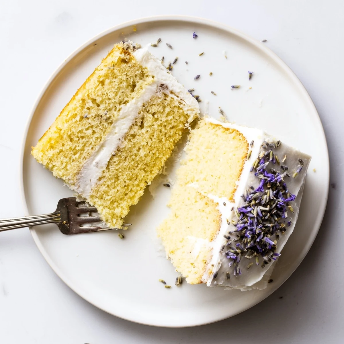 Sliced London Fog cake revealing tender Earl Grey lavender crumb, ready to serve with a hot cup of tea.  