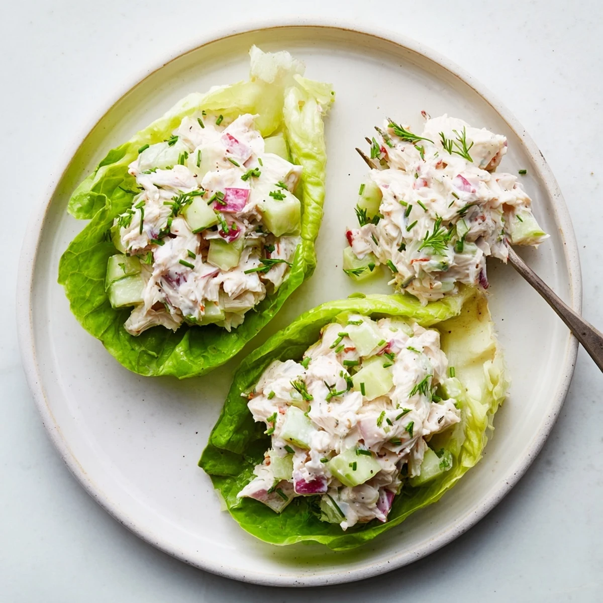 Freshly made Crab Salad served on crisp butter lettuce with lemon wedges, perfect for a light summer lunch or appetizer.