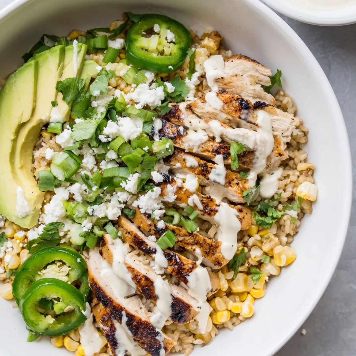 Vibrant Street Corn Chicken Bowl with juicy grilled chicken, charred sweet corn, and creamy lime crema over rice.