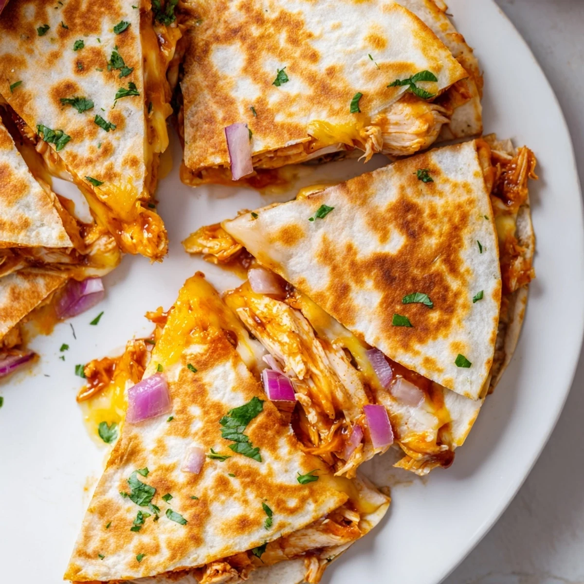 Hot honey BBQ chicken quesadillas with melty mozzarella and cheddar in a golden crispy tortilla.