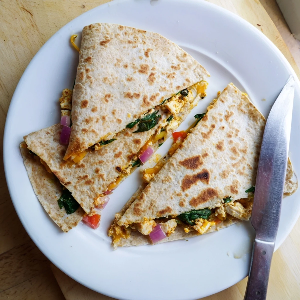 Hearty high protein quesadilla filled with seasoned grilled chicken crisp tortilla and colorful bell peppers