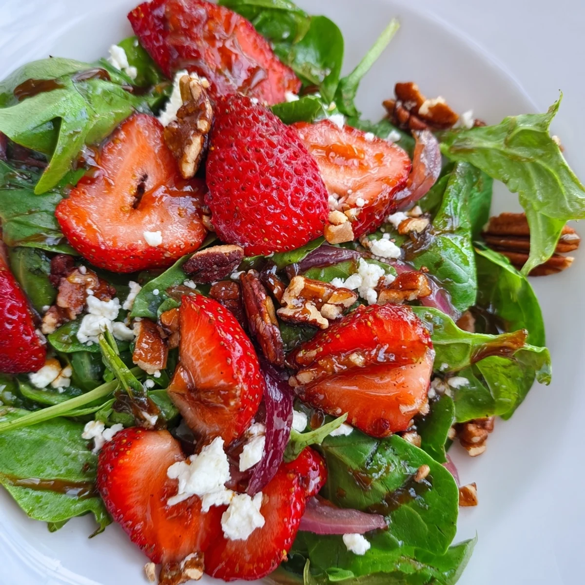 Colorful strawberry crunch salad bowl featuring juicy strawberries, mixed greens, and crunchy fried onions