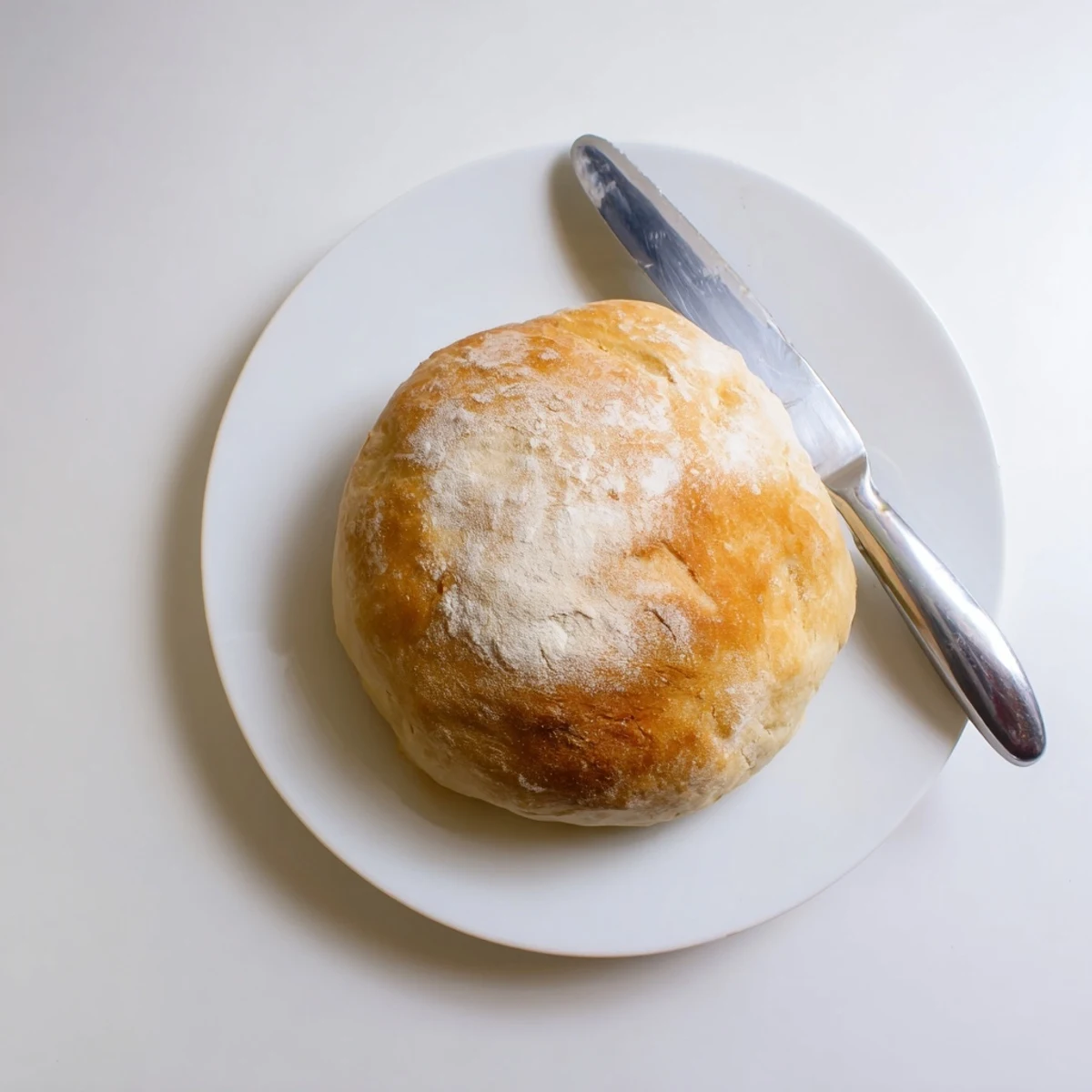 Warm skillet bread loaf sliced to reveal soft white crumb perfect for buttering