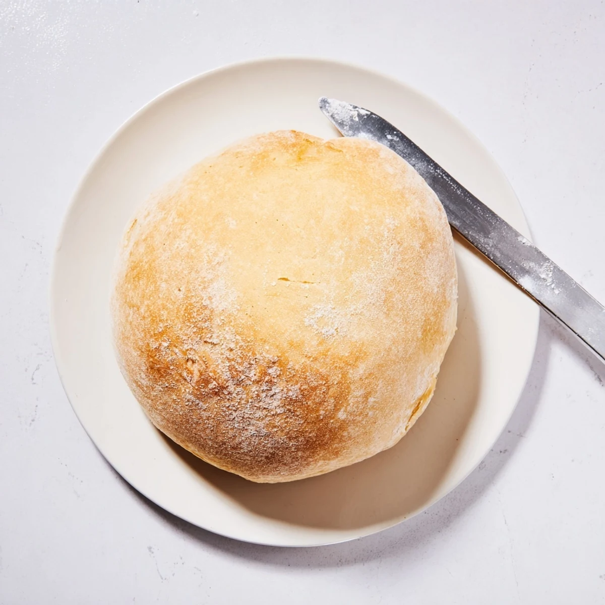 Round pan-fried bread with golden crust resting on wire rack ready to serve