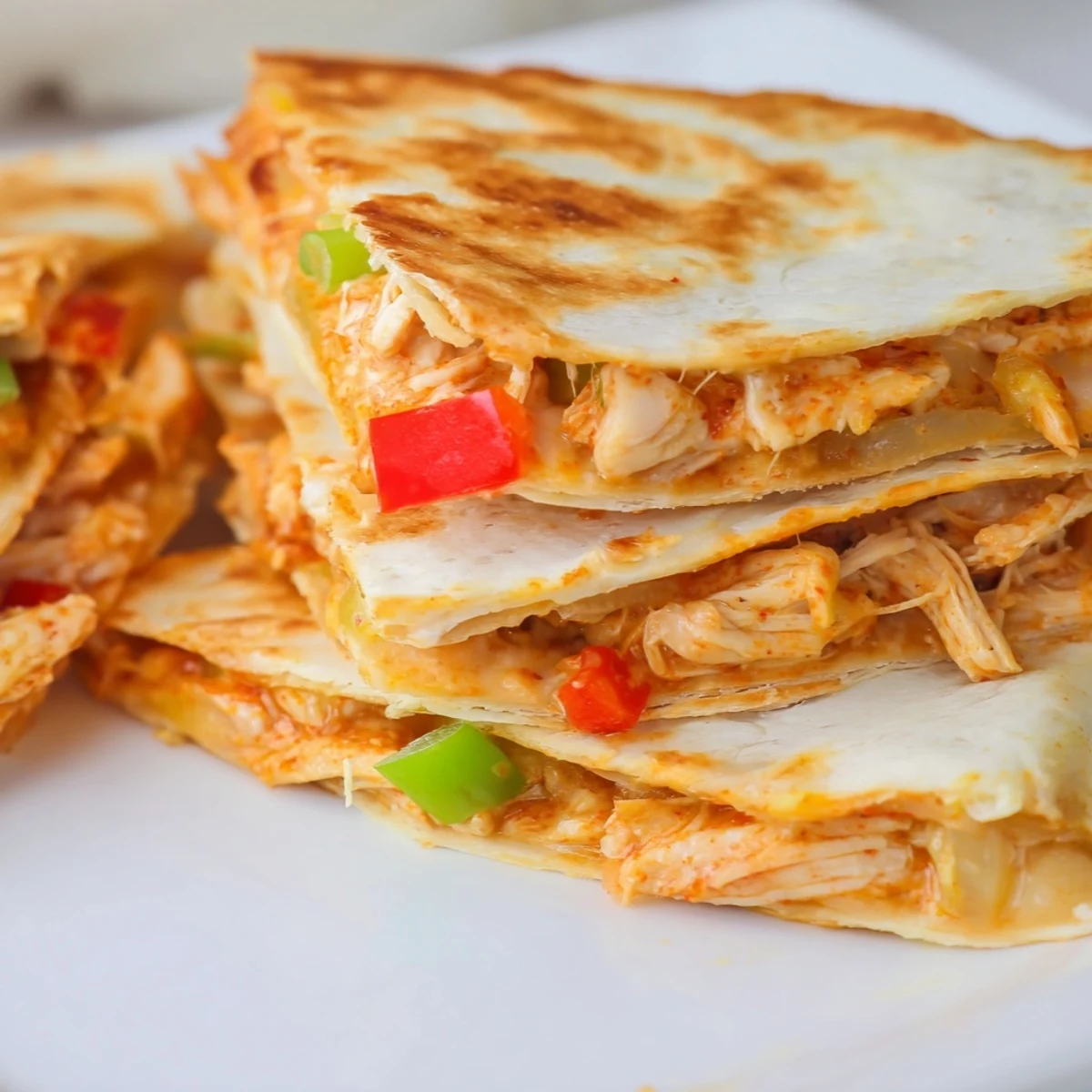 Golden baked chicken and cheese quesadillas with spicy seasoning and melted cheese layers