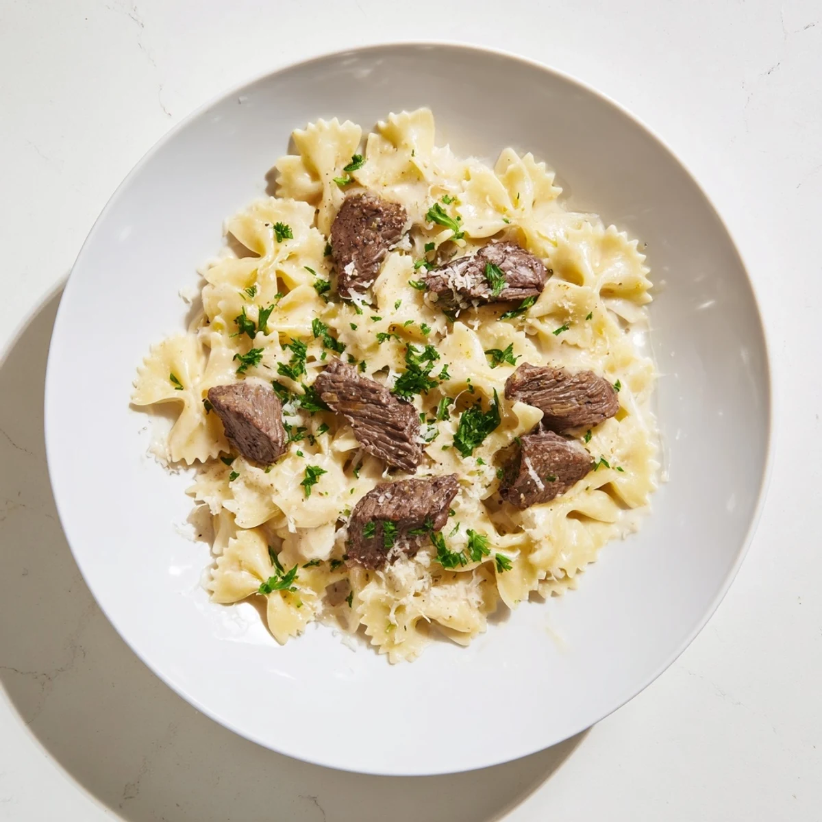 Zesty Alfredo bowties tossed with Cajun cream sauce and seasoned beef strips
