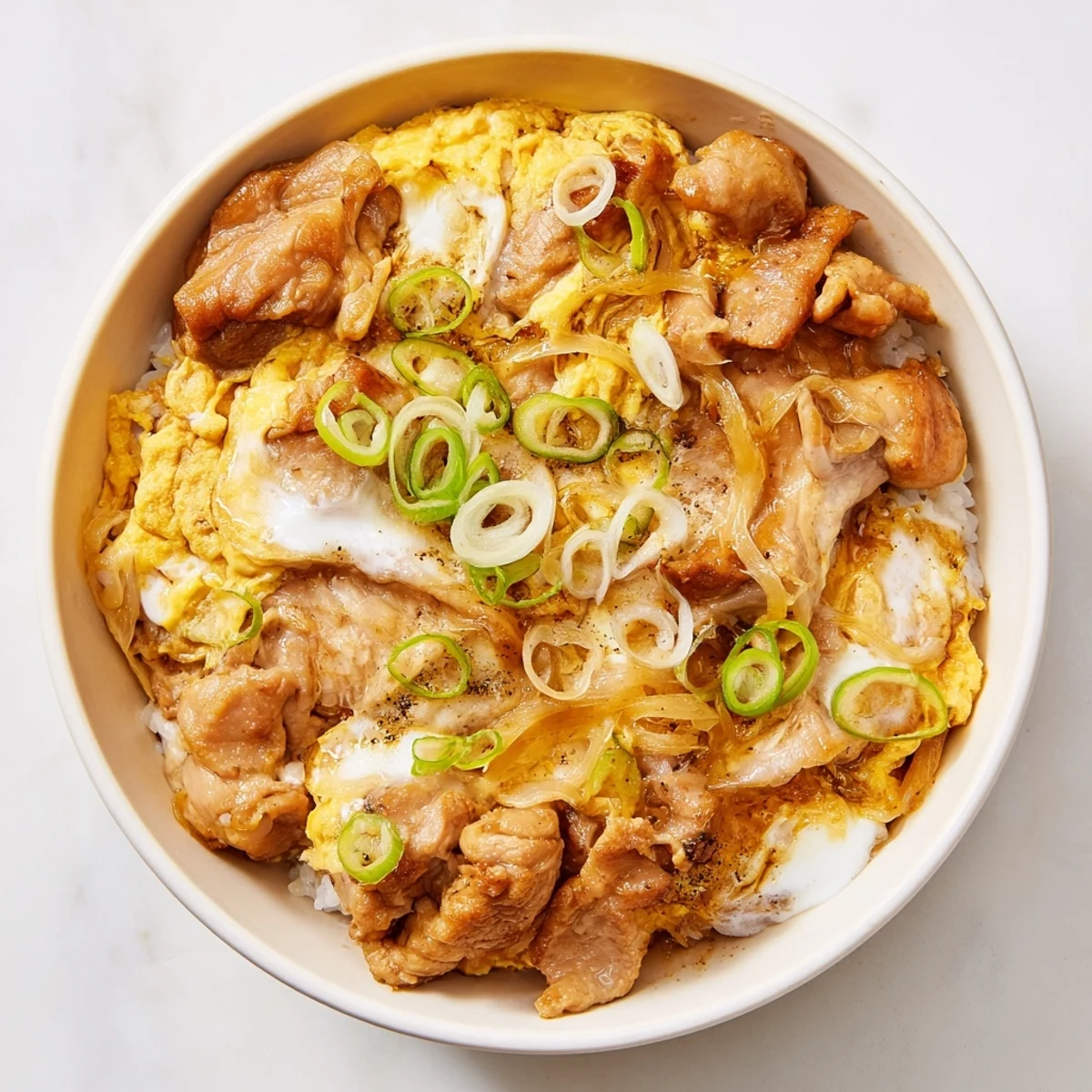 Japanese Oyakodon comfort food with savory chicken onions and creamy custard-like eggs