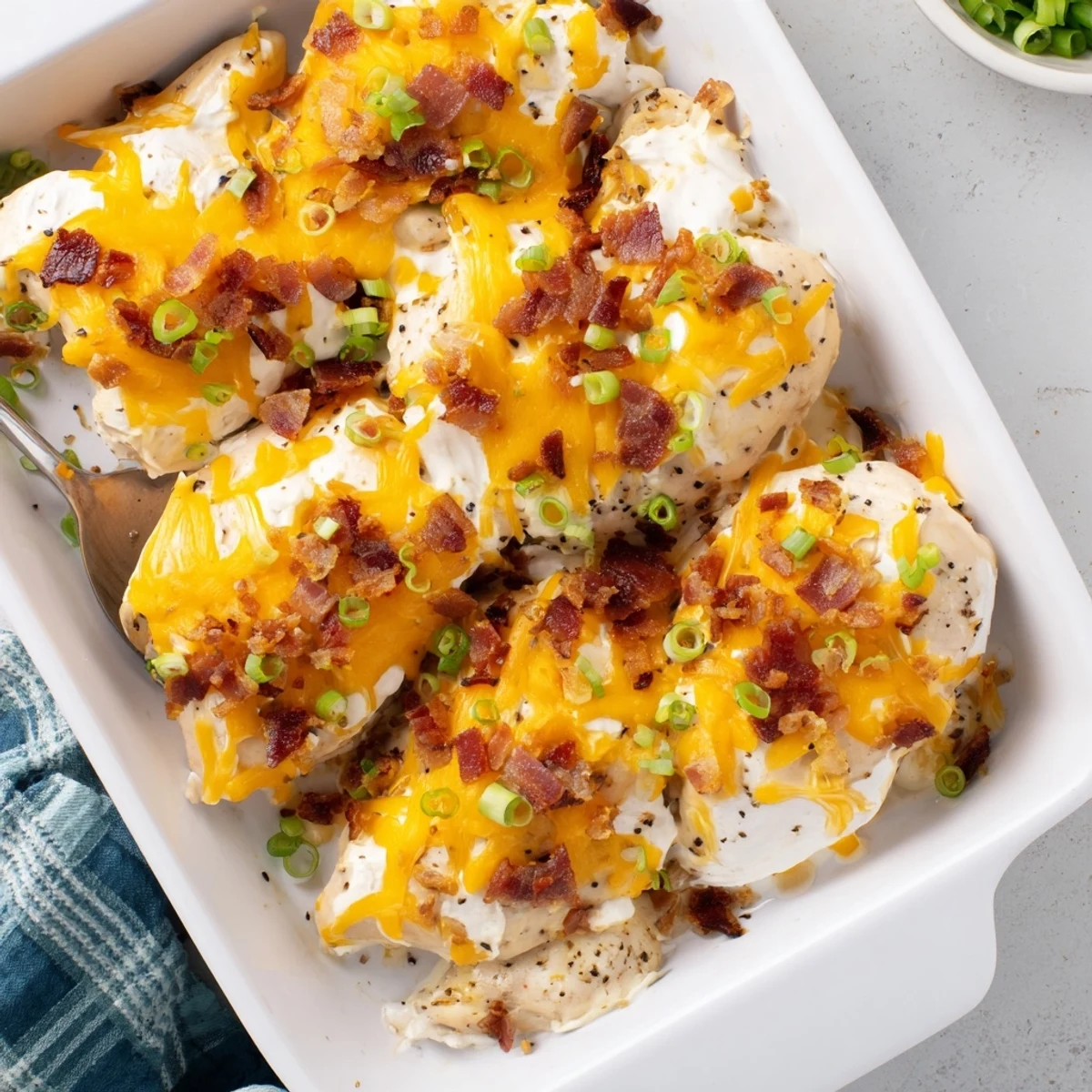 Creamy crack chicken topped with melted cheddar and crispy bacon strips