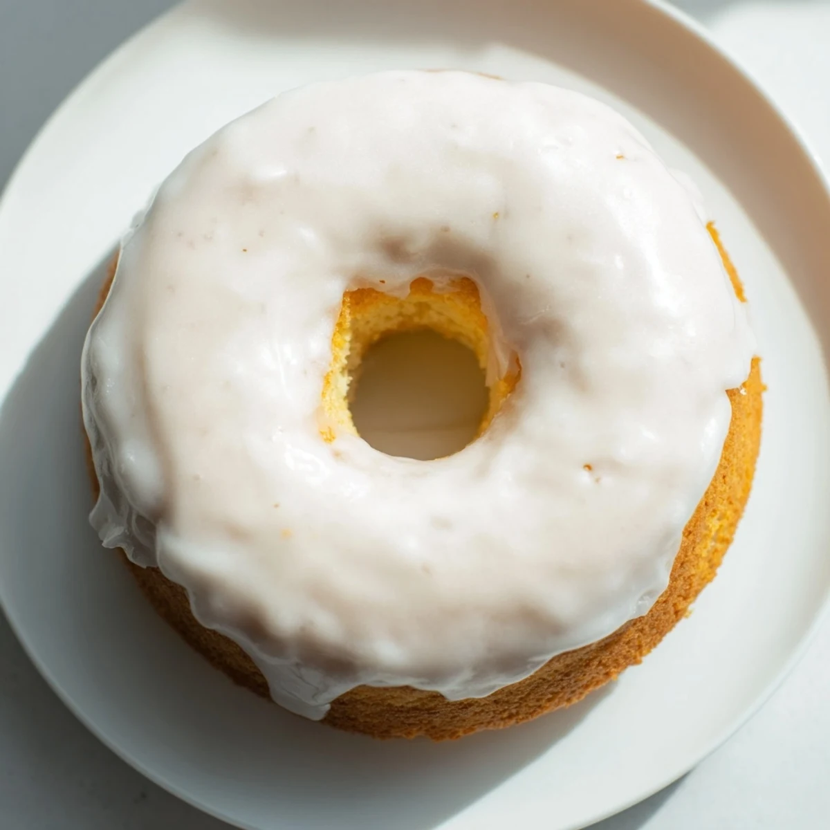 Light and fluffy Greek yogurt cake donuts arranged on white wire cooling rack