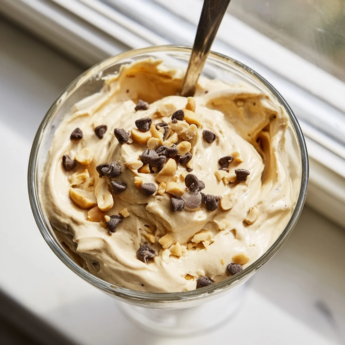 Creamy Peanut Butter and Cool Whip Mousse topped with chocolate shavings in clear serving glasses