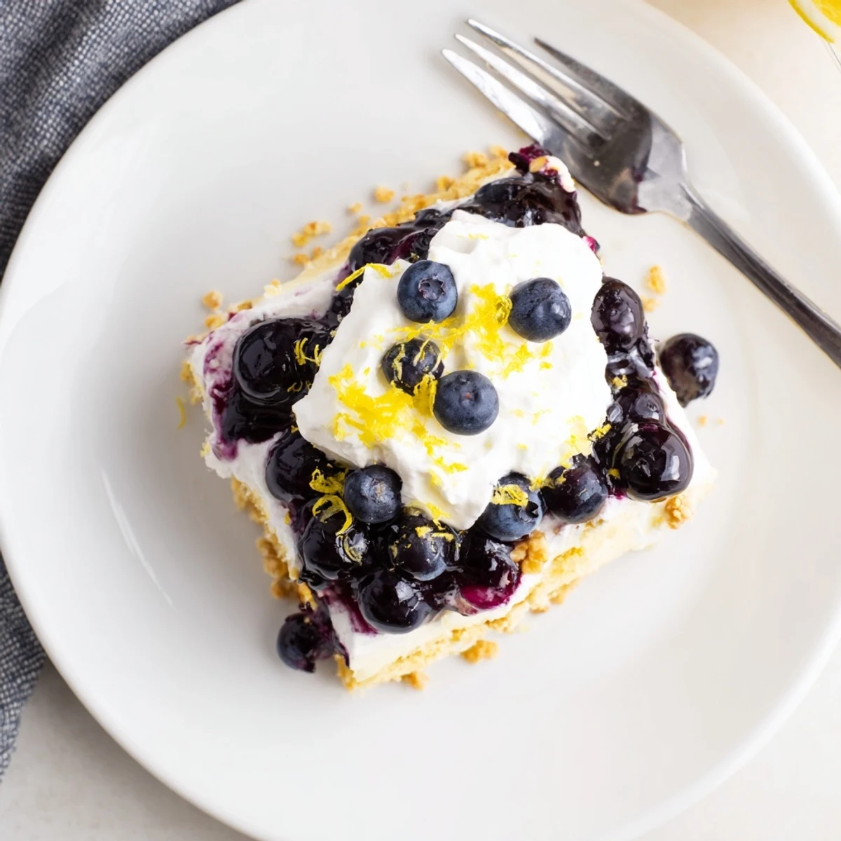 Layered lemon blueberry lasagna recipe with creamy filling and fresh berry swirls