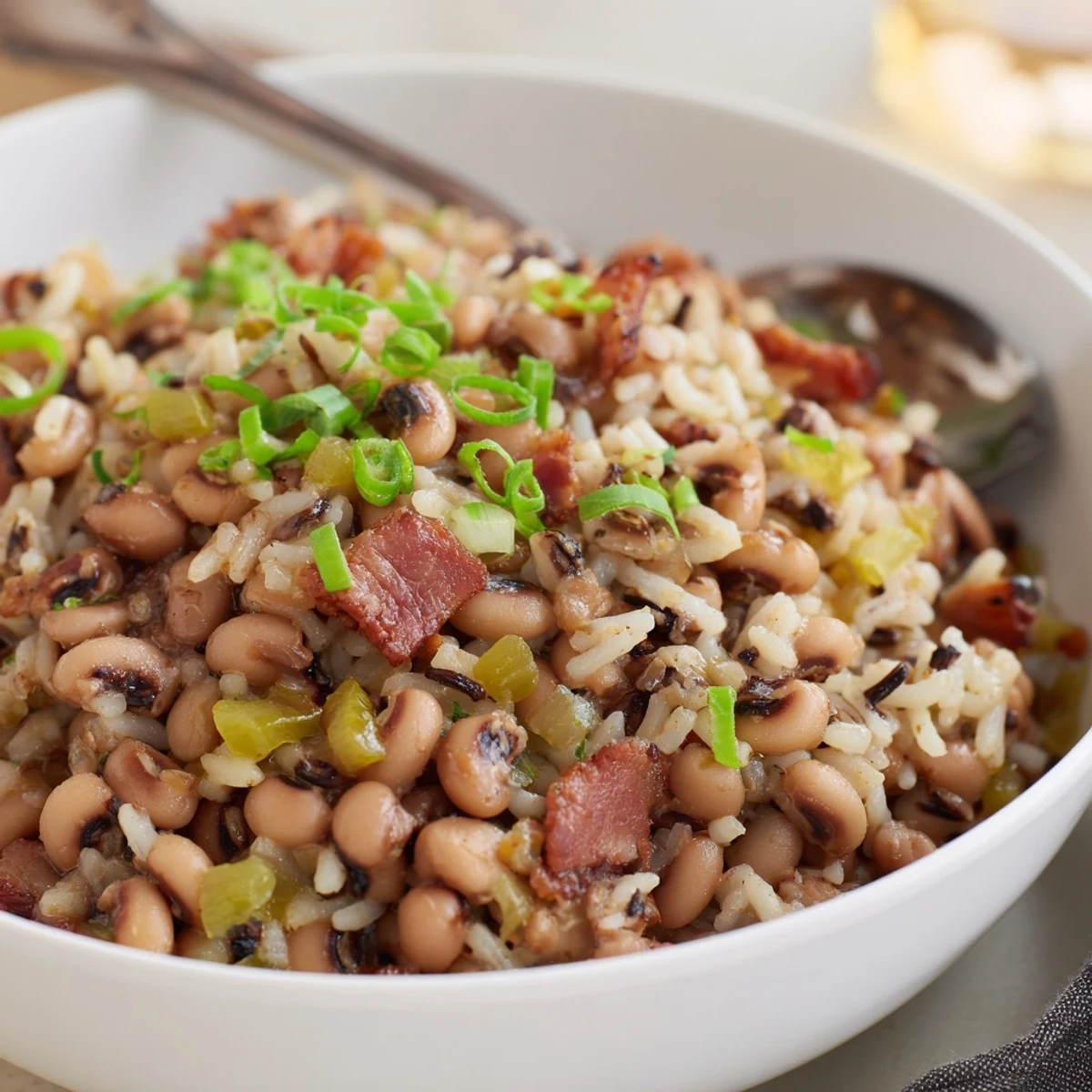 Hearty Smoky Southern Hoppin John in Dutch oven with cornbread beside.