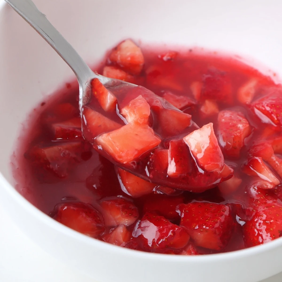 Strawberry Cake Filling Recipe simmering glossy, bright red berries perfect for cake layers.