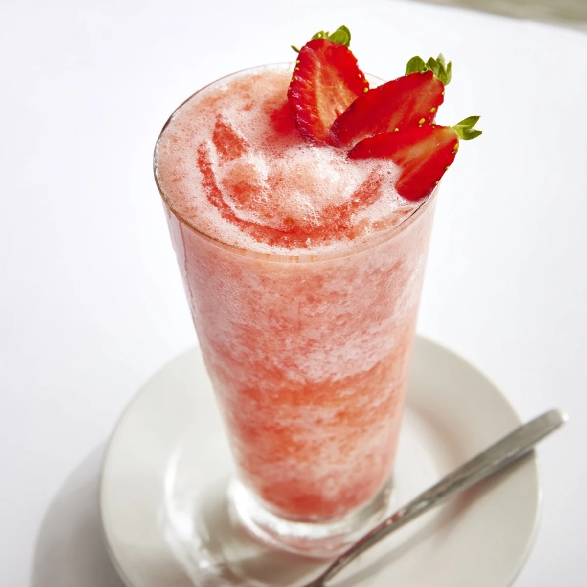 Iced Strawberry Coconut Cooler served in tall glasses, bright lime and mint