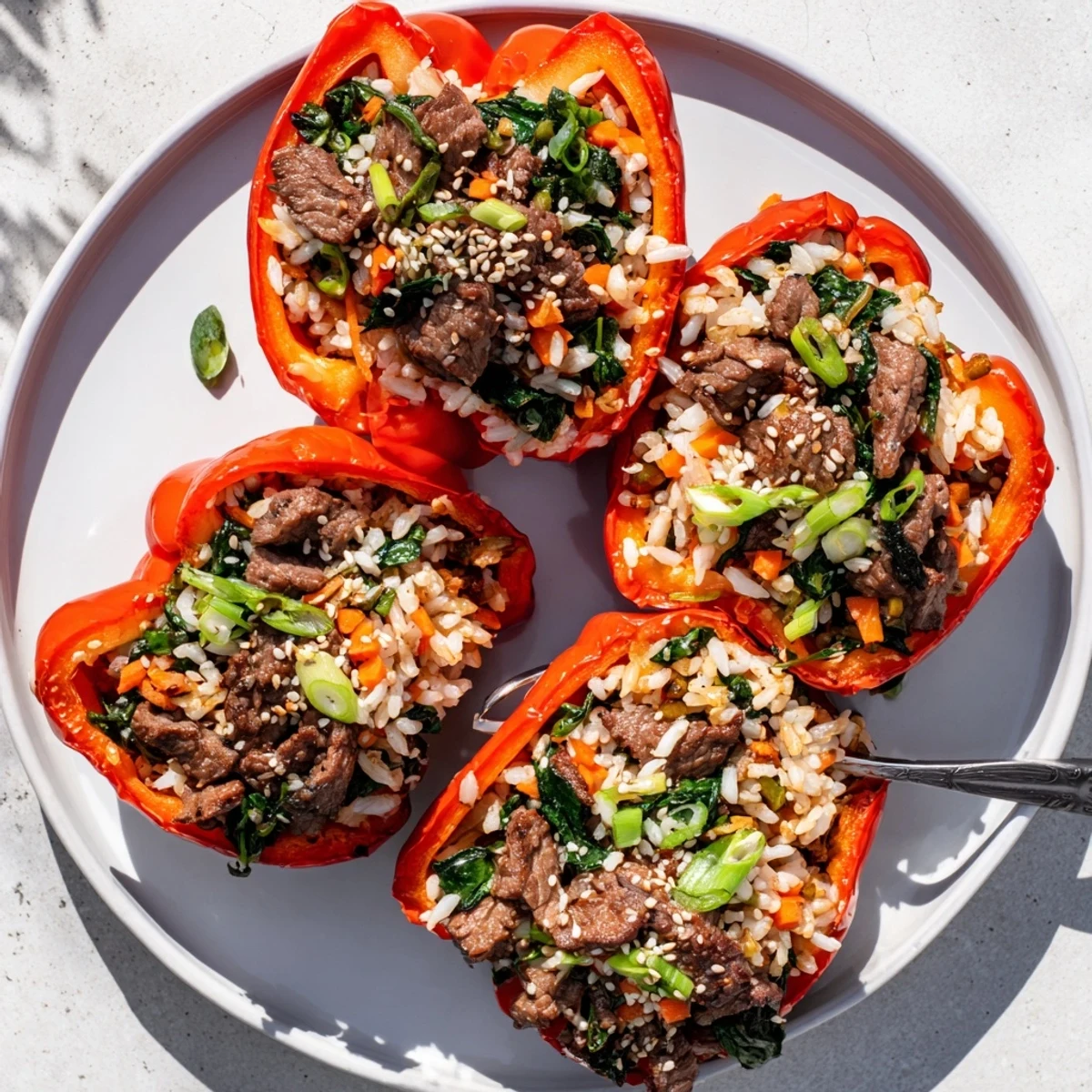 Golden marinated beef stuffed inside colorful roasted peppers garnished with sesame seeds and scallions