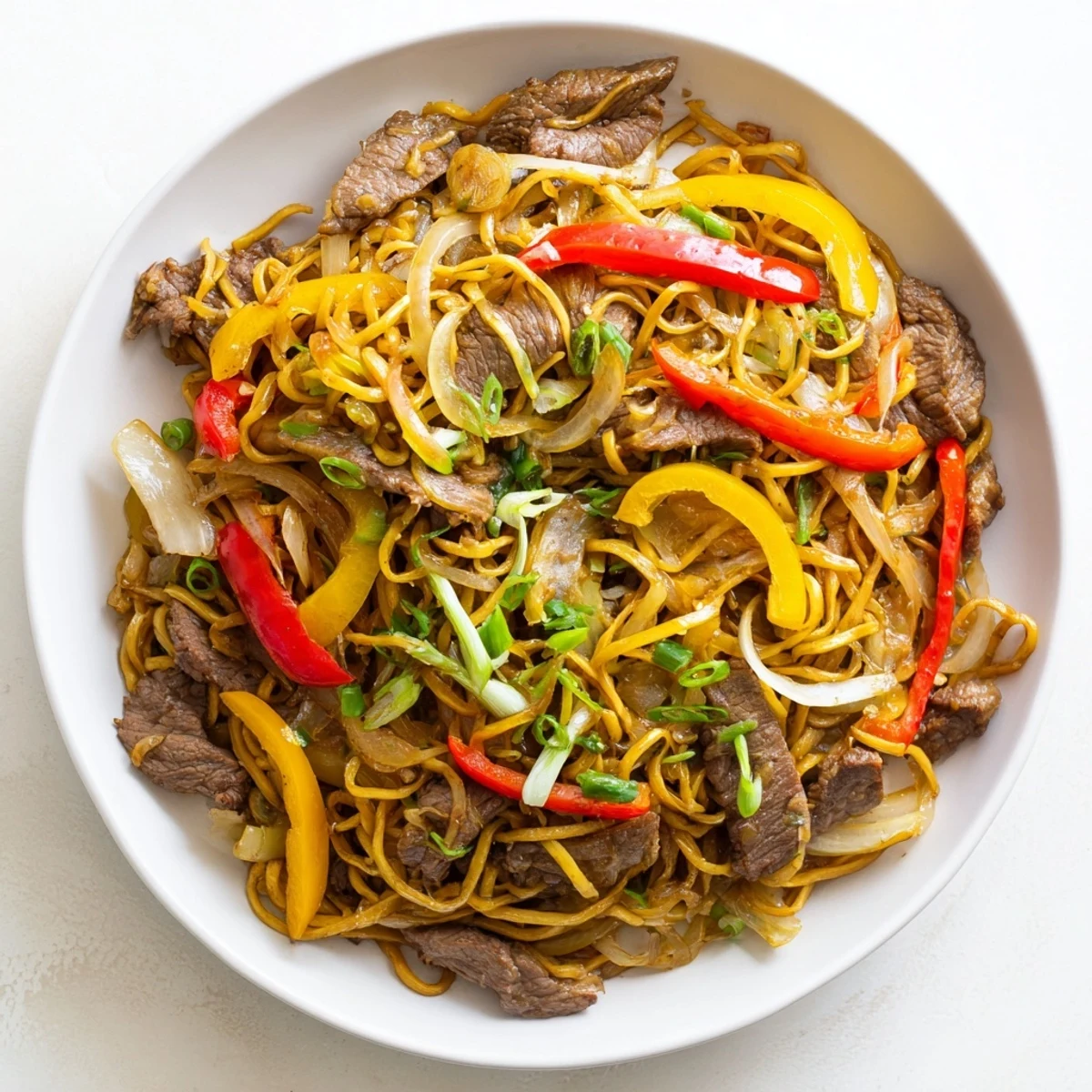 Beef chow mein served with tender strips of beef, crisp peppers, and caramelized onions