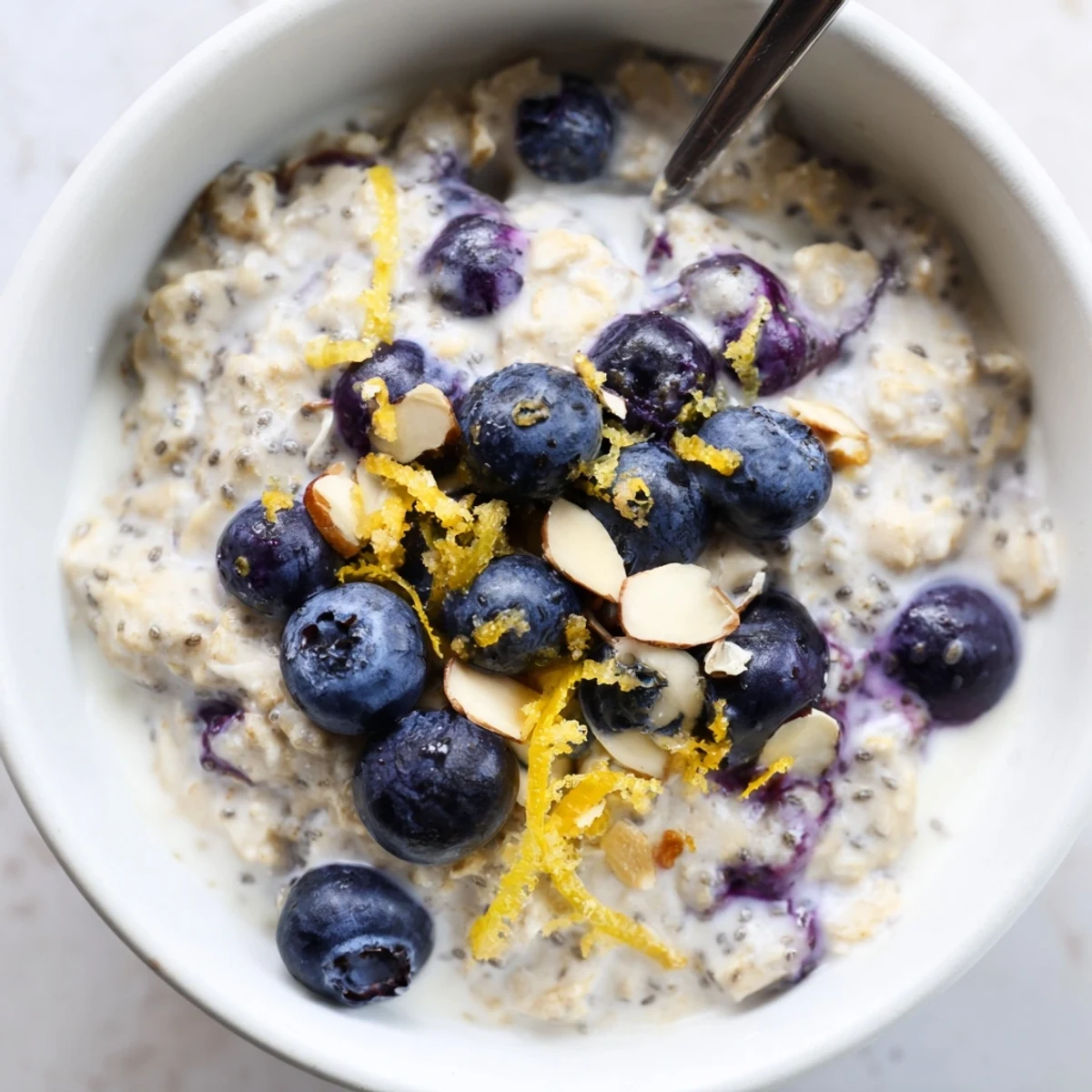 Creamy Blueberry Lemon Overnight Oats topped with extra berries and lemon zest