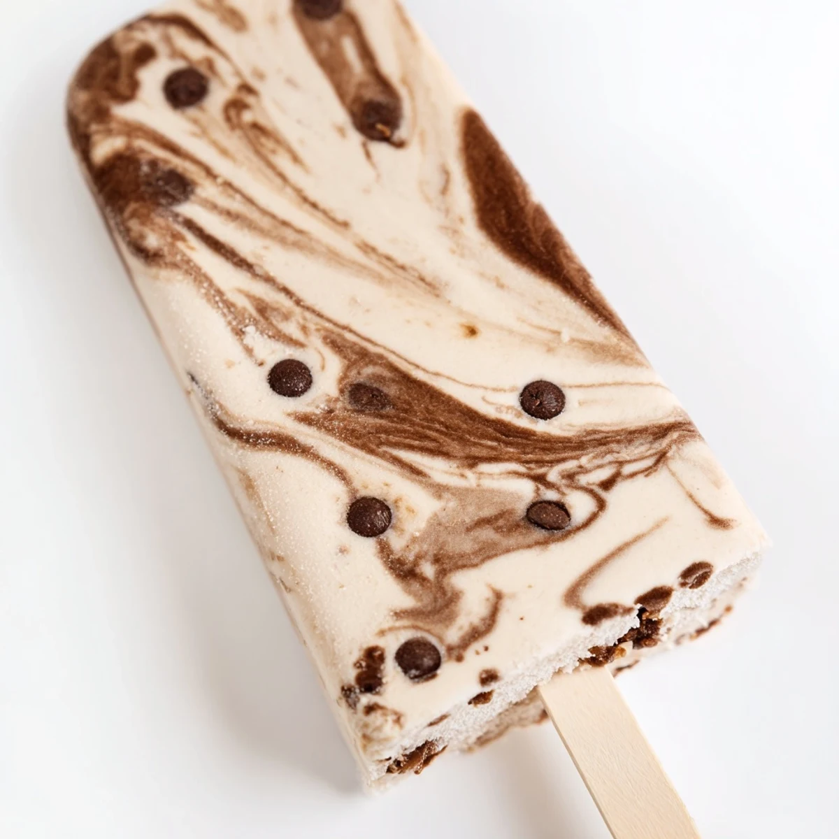 Frozen chocolate banana bliss popsicles with marbled chocolate swirls glisten melting on a white serving plate