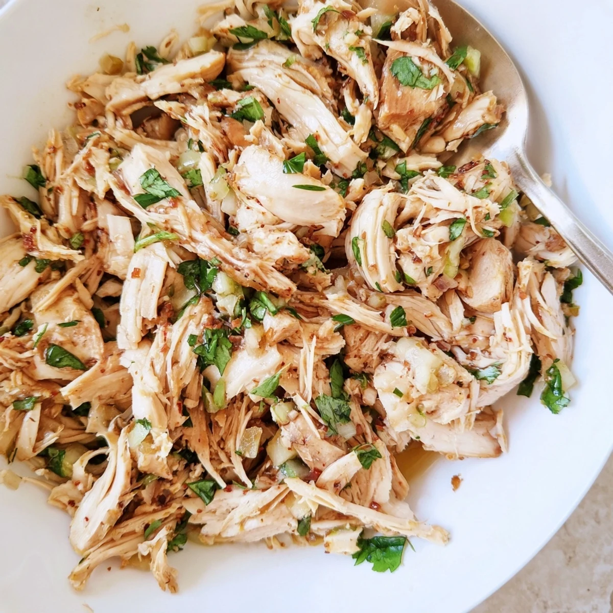 Slow Cooker Cilantro Lime Chicken shredded, steaming, bright cilantro sprigs and lime