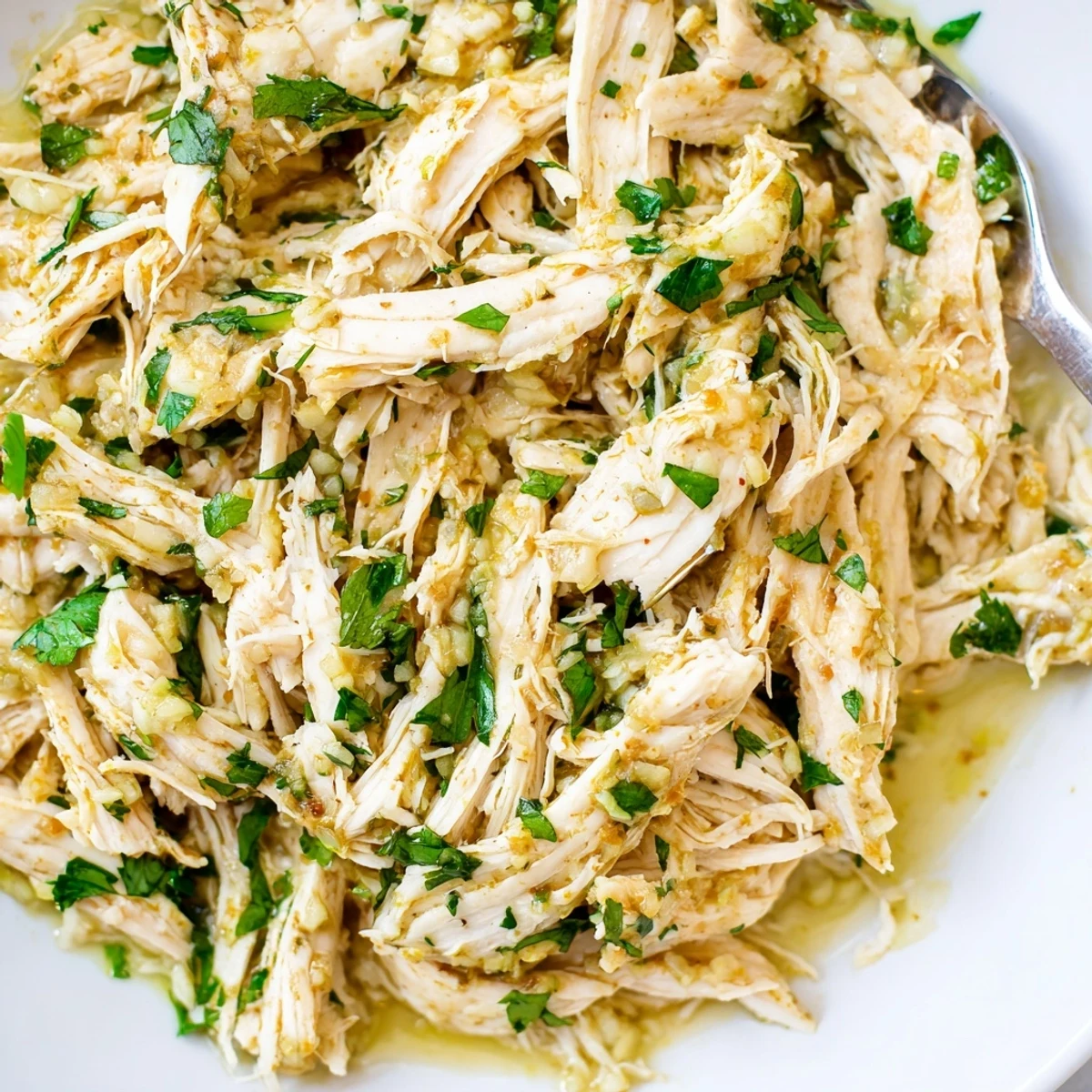 Juicy Slow Cooker Cilantro Lime Chicken over rice, garnished with avocado slices