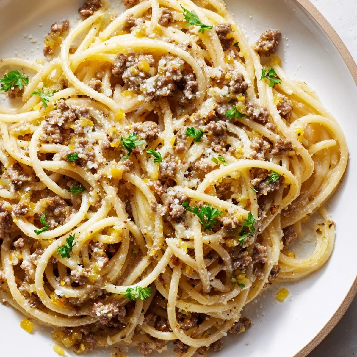 Golden buttery garlic butter pasta with ground beef served in a cast iron skillet
