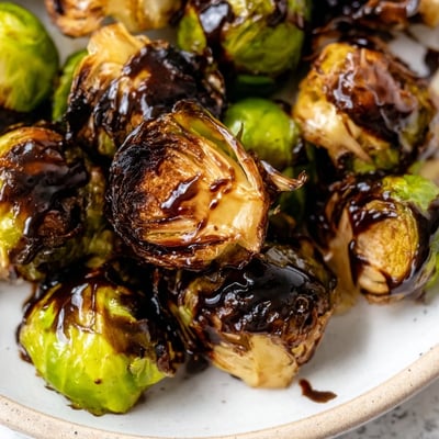 Freshly roasted Brussels Sprouts with Balsamic Glaze Reduction feature crispy edges and a tangy glaze.