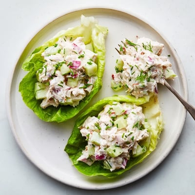 Freshly made Crab Salad served on crisp butter lettuce with lemon wedges, perfect for a light summer lunch or appetizer.