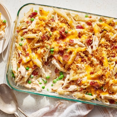 Serving suggestion of Crazy Good Casserole garnished with fresh thyme and served on a rustic farmhouse table.