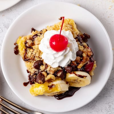 Sliced bananas and pineapple peeking through golden Banana Split Dump Cake