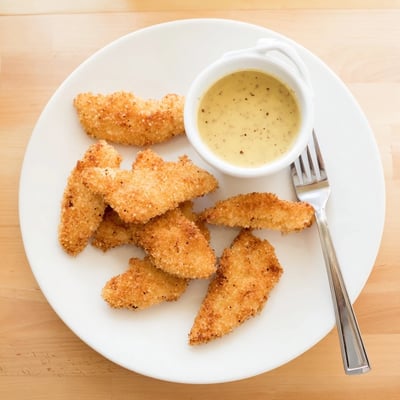 Fried honey mustard chicken tenders served with tangy honey mustard sauce for dipping