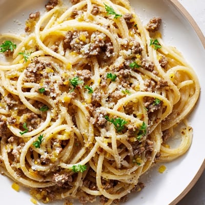 Golden buttery garlic butter pasta with ground beef served in a cast iron skillet